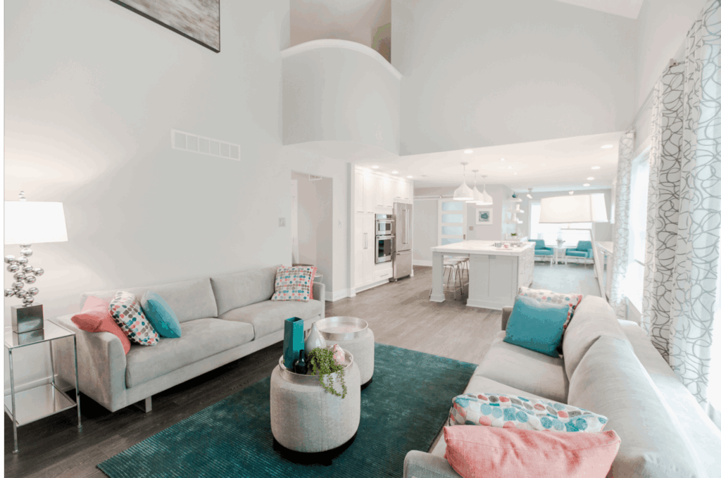 Open-concept two-story family room flowing into expansive kitchen and dining area. Remodeled for accessibility.