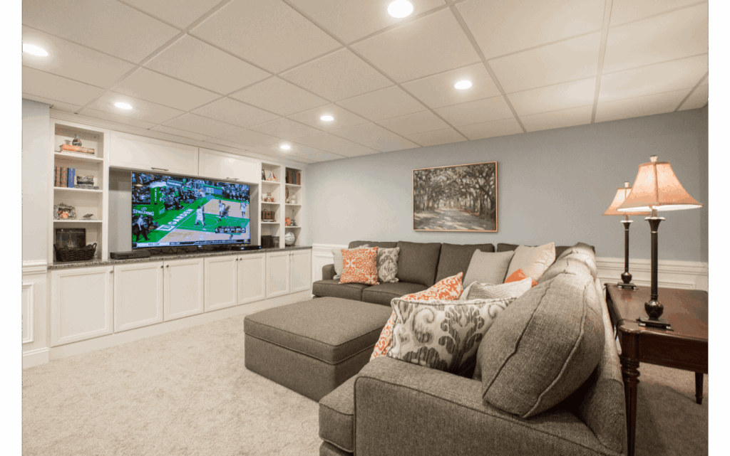 Finished basement living area with white/beige carpet.
