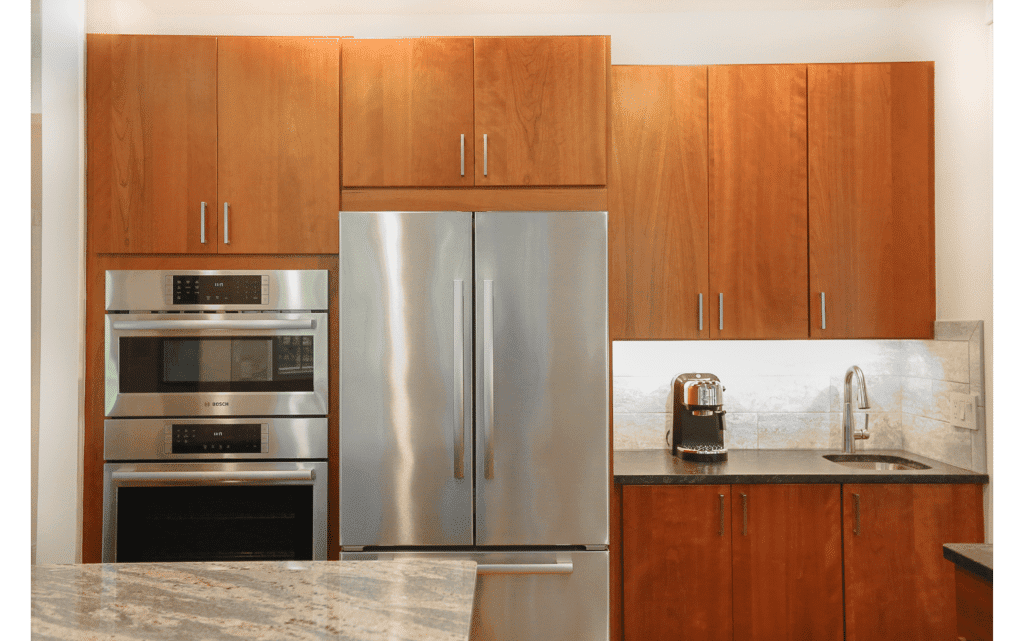 Woodgrain modern/flat-panel cabinets in a modern style kitchen with stainless steel appliances.