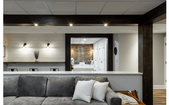 living room renovation with dark brown wooden beams pendant lighting large mirror