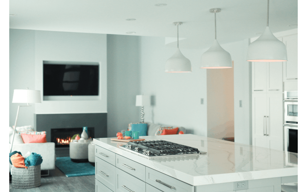 living room renovation white large pendant lighting over white granite countertop stove on top of island