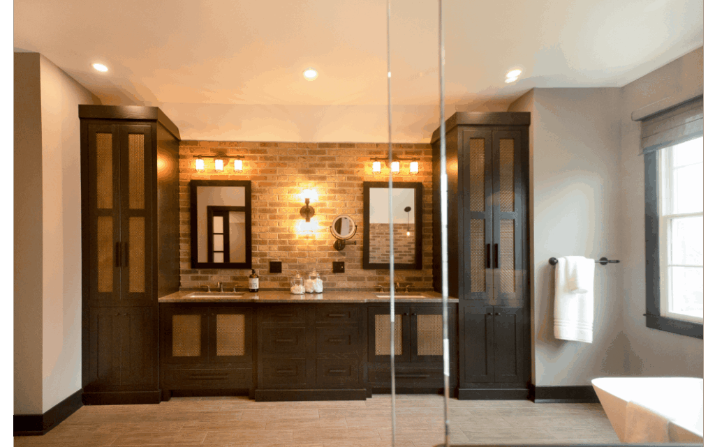 Large primary bath with dual vanity, recessed lighting, large window letting in natural light, glass shower enclosure, and corner view of bathtub