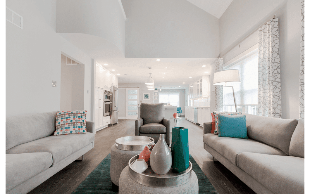 Open-concept two-story family room flowing into expansive kitchen and dining area